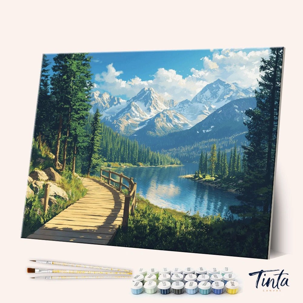 Angled view of Alpine Pathway paint by numbers kit featuring wooden trail beside lake and mountains by Tinta Canvas