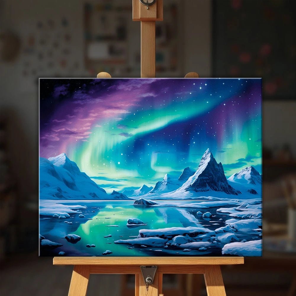 Arctic Glow paint by numbers kit displayed on an easel showing colorful northern lights sky over snowy mountains by Tinta Canvas