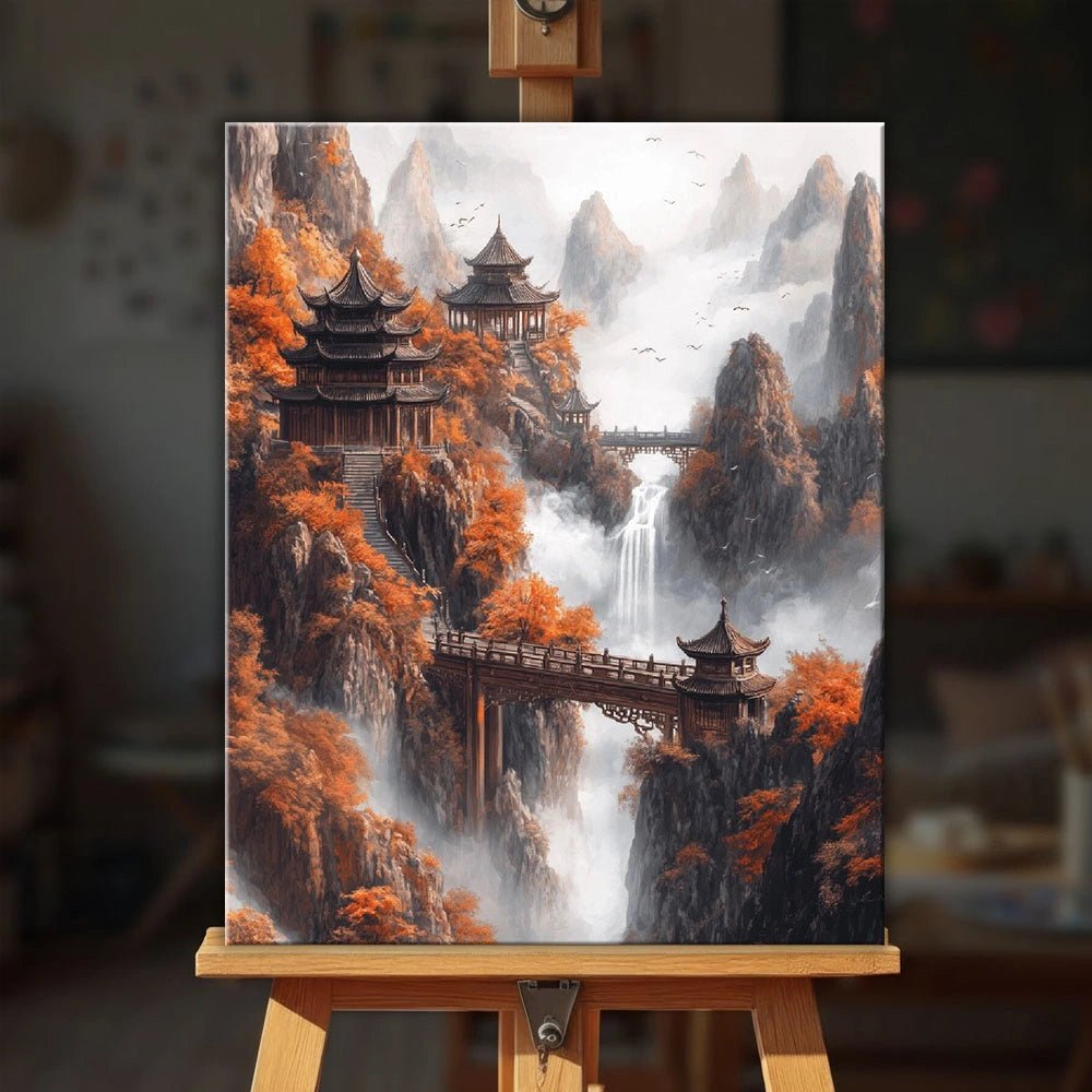 Autumn Mountain Sanctuary paint by numbers kit displayed on an easel showing peaceful pagodas and waterfalls in autumn mountains by Tinta Canvas