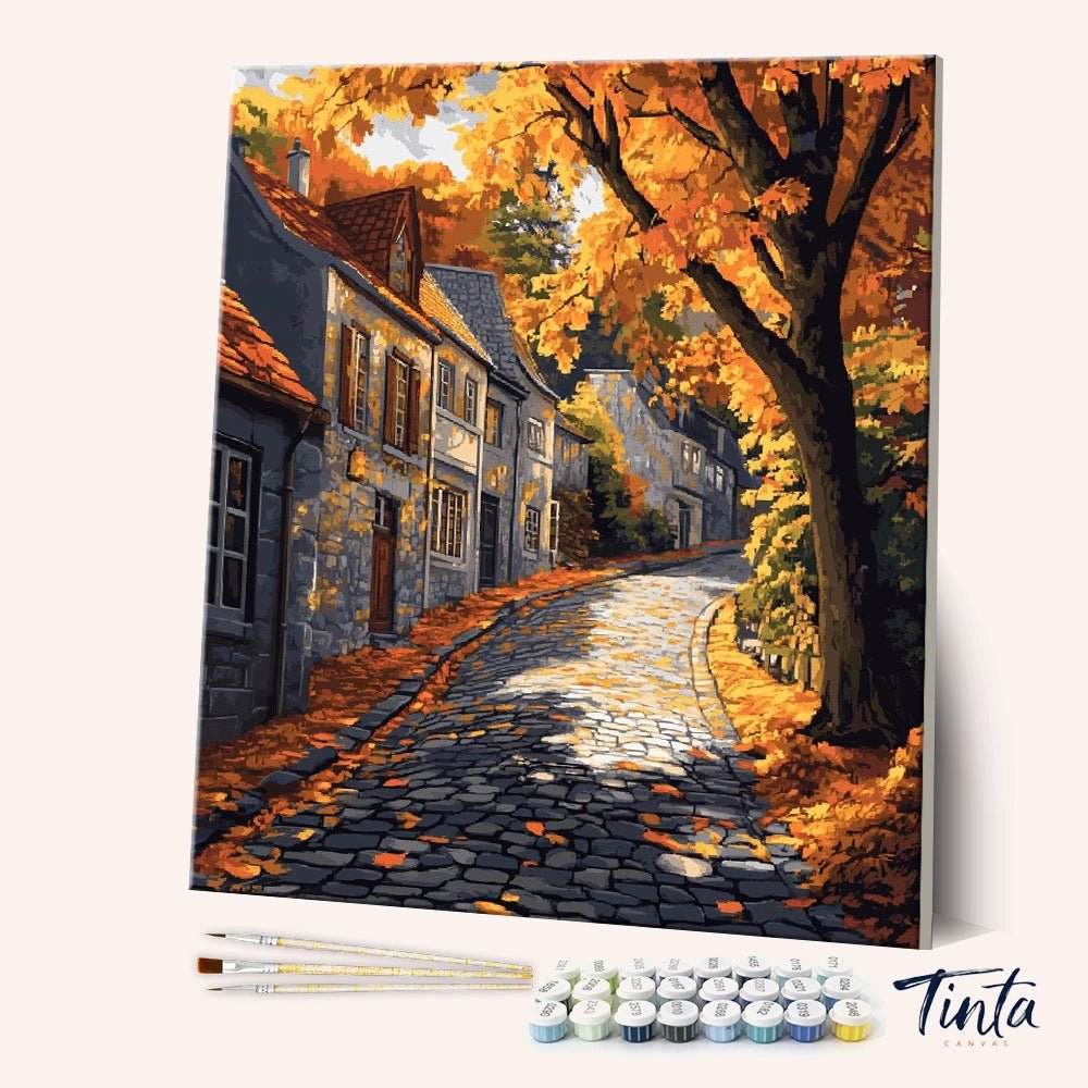 Angled canvas view of Autumnstone Lane paint by numbers kit with cobblestone street and golden trees by Tinta Canvas