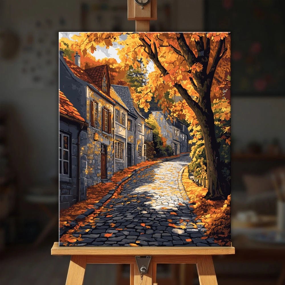 Autumnstone Lane paint by numbers kit displayed on an easel in a cozy interior setting by Tinta Canvas