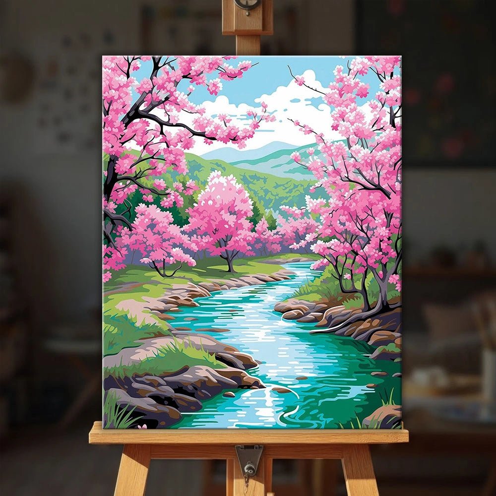 Blossom River Trail paint by numbers kit displayed on easel with peaceful spring river and blooming trees