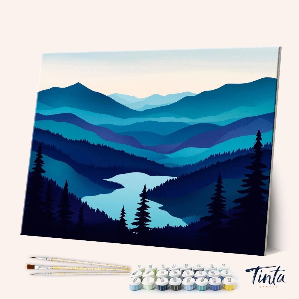 Angled view of Blue Valley Stillness paint by numbers kit featuring layered blue mountains and winding river by Tinta Canvas