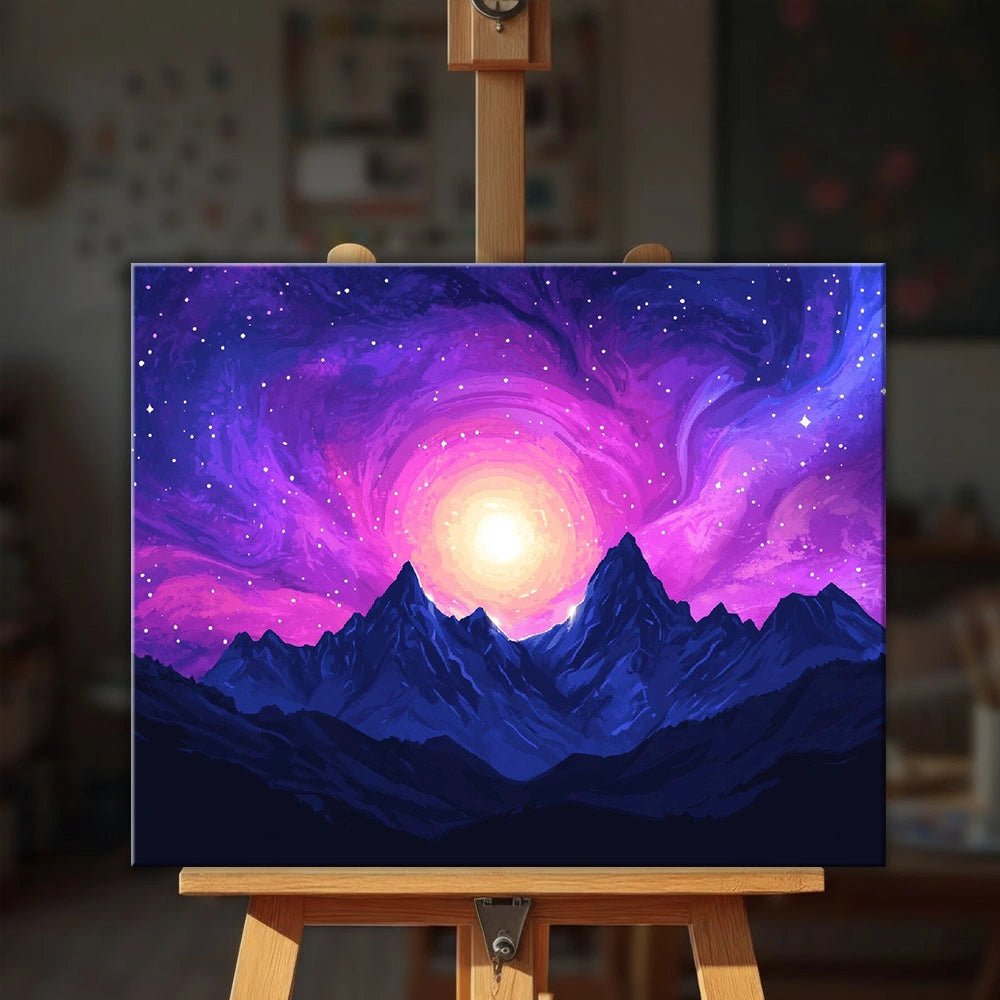 Celestial Awakening paint by numbers kit displayed on an easel with vibrant nebula colors glowing over mountain peaks by Tinta Canvas