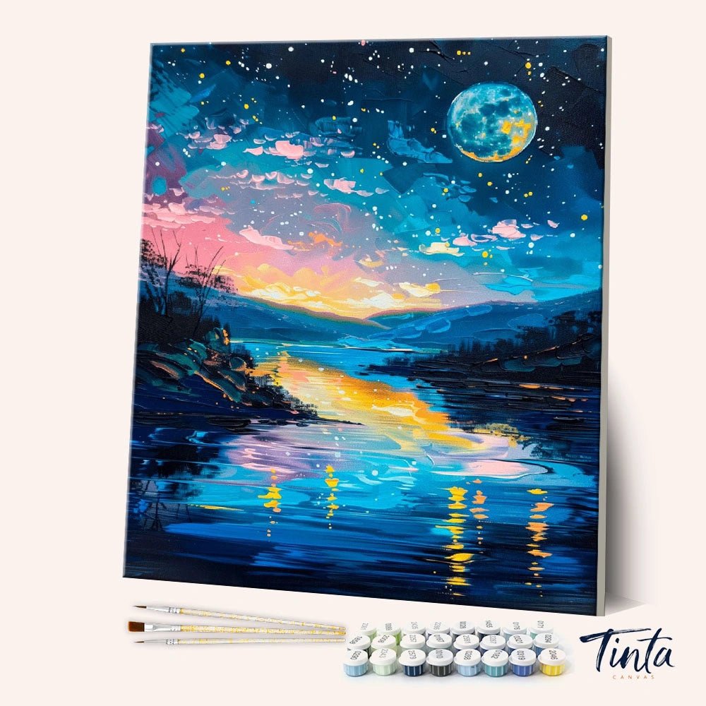 Angled display of the Celestial River Glow paint by numbers kit showing glowing river landscape canvas with brushes and paints by Tinta Canvas
