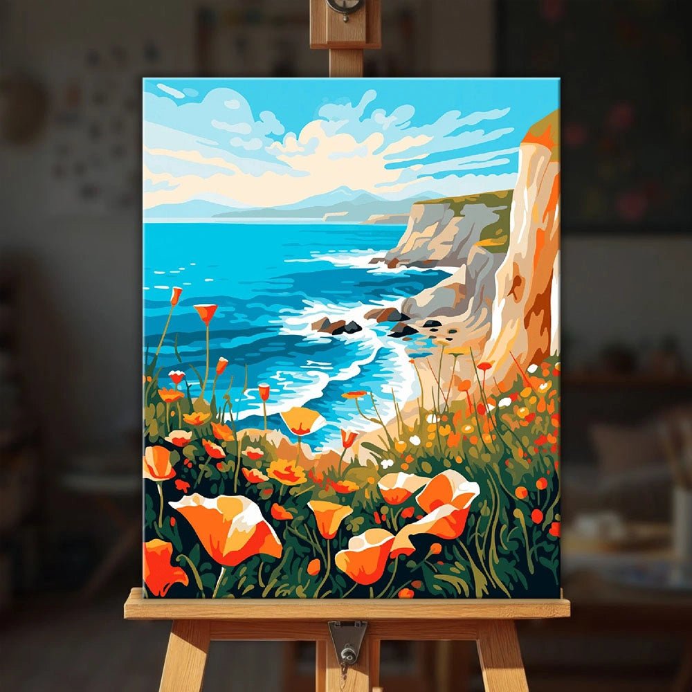 Coastal Poppy Cliffs paint by numbers kit displayed on easel in home setting highlighting coastal scenery and vibrant flowers by Tinta Canvas