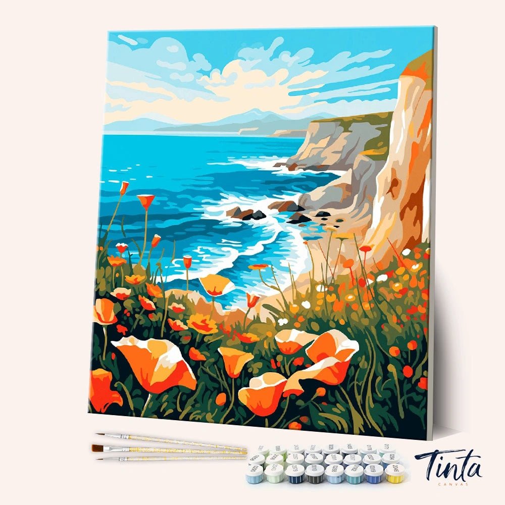 Angled view of Coastal Poppy Cliffs paint by numbers kit showing ocean cliffs with orange poppies and tools included by Tinta Canvas