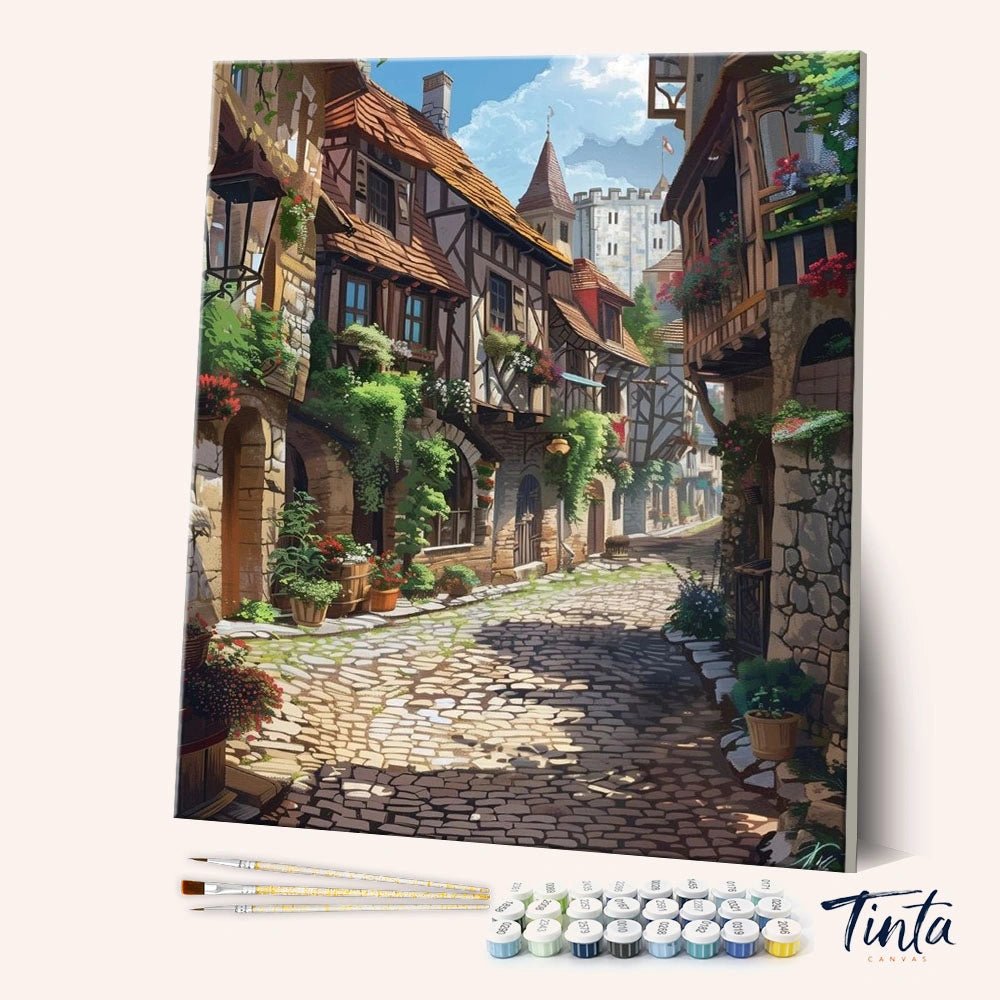Cobblestone Morning paint by numbers kit showing a charming cobblestone street lined with cozy houses and flowers by Tinta Canvas