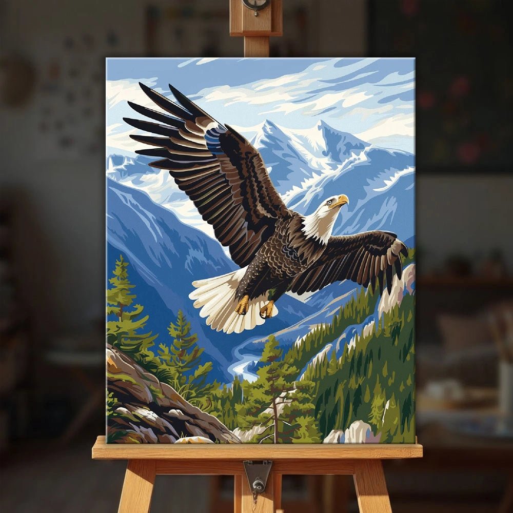Eagle Flight paint by numbers kit displayed on an easel showing an eagle gliding over mountains and forest by Tinta Canvas