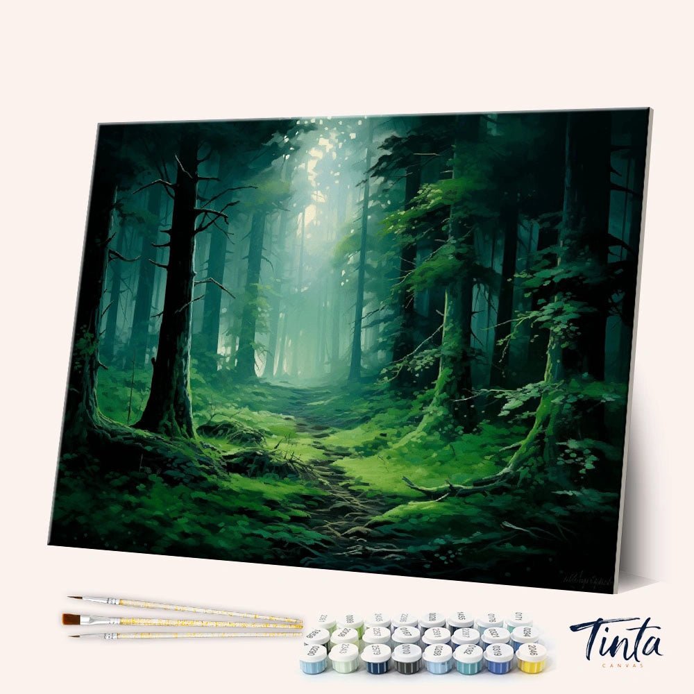 Angled display of the Emerald Forest Path paint by numbers kit showing lush green forest canvas with brushes and paints by Tinta Canvas