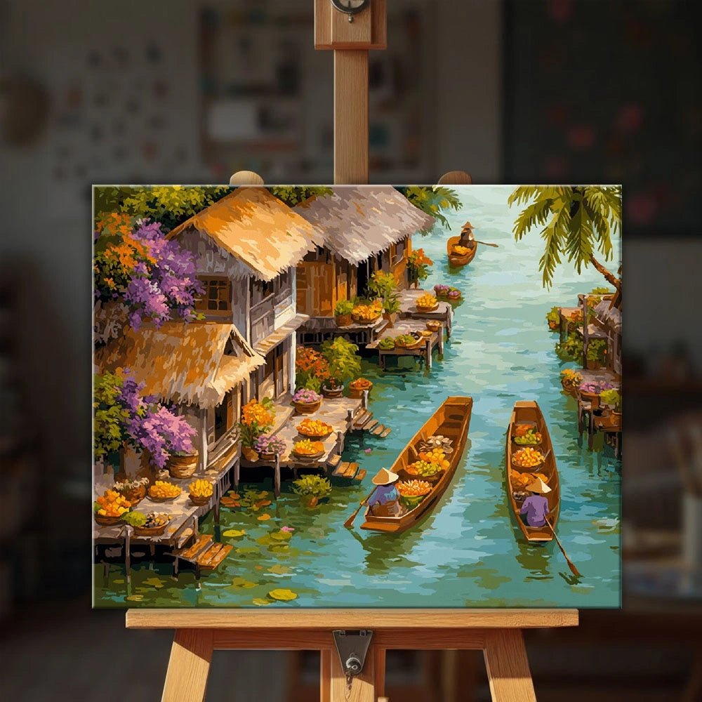 Floating Market paint by numbers kit displayed on an easel showing vibrant canal market scene with boats and waterside homes by Tinta Canvas