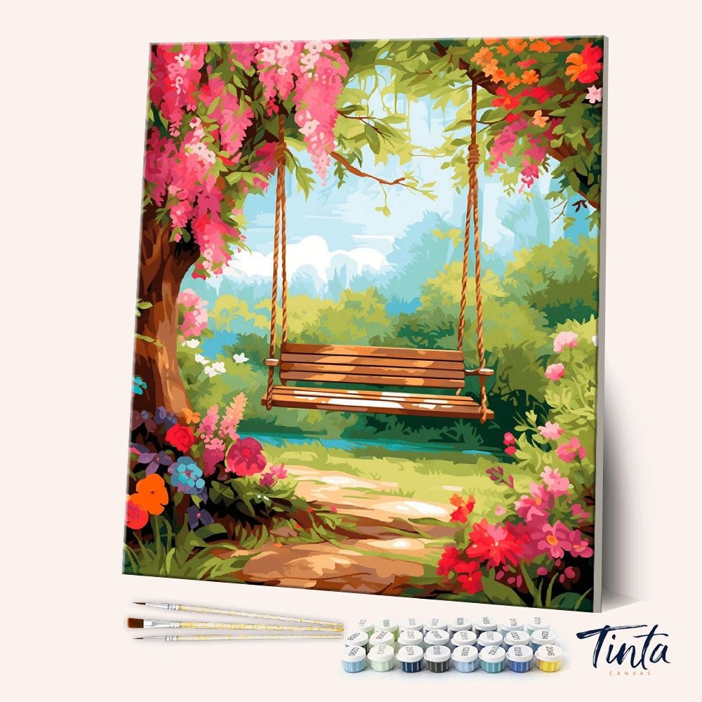 Garden Swing Daydream paint by numbers kit showing a wooden swing hanging from a flowering tree in a bright garden by Tinta Canvas