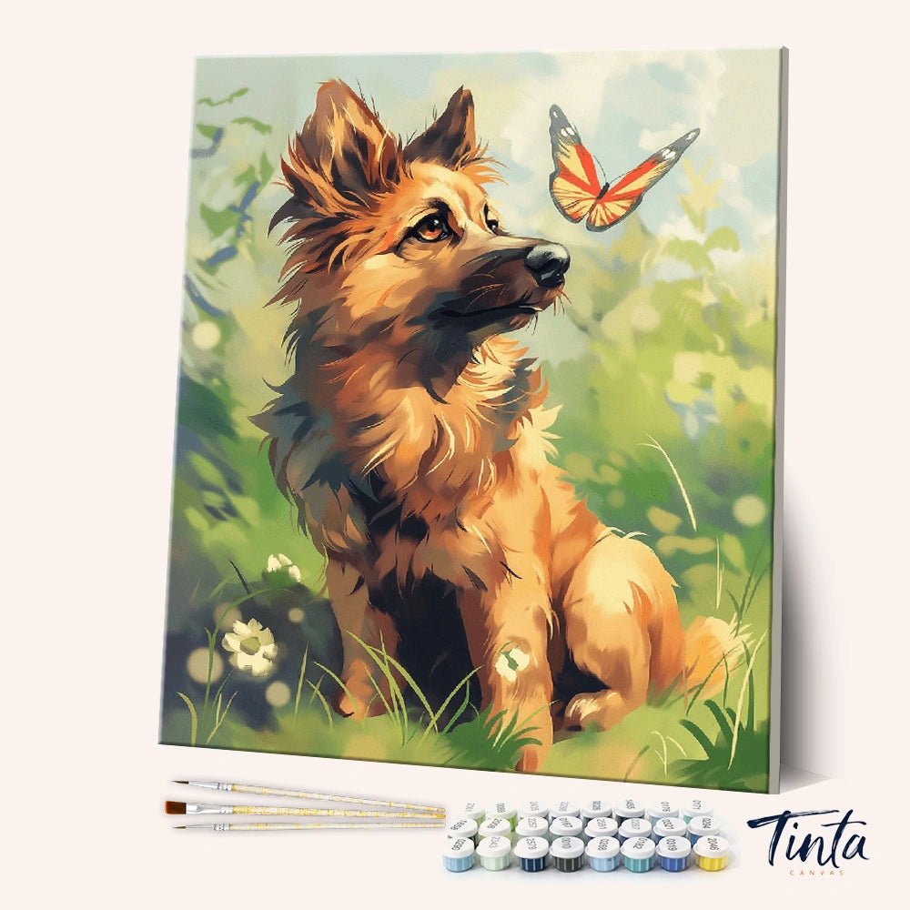 Angled display of the Gentle Curiosity paint by numbers kit showing a curious puppy watching a butterfly in a sunlit meadow by Tinta Canvas