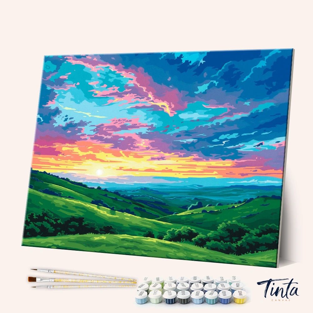 Angled view of Golden Valley paint by numbers kit showing vibrant sunset sky over rolling green hills with tools included by Tinta Canvas