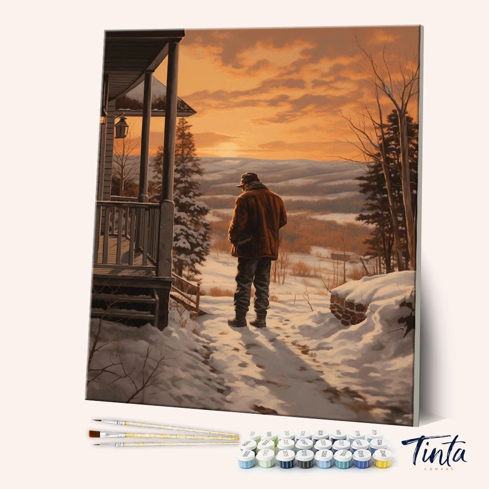 Hearthside Horizon paint by numbers kit angled display showing winter cabin scene canvas with paint pots and brushes by Tinta Canvas