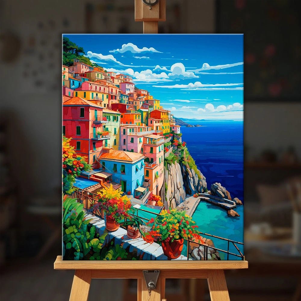 Italian Coast paint by numbers kit displayed on an easel showing bright coastal village painting with sea cliffs and colorful homes by Tinta Canvas