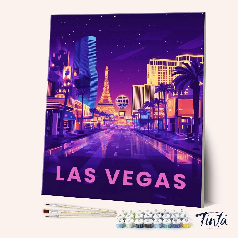 Las Vegas Neon Nights paint by numbers kit angled display showing neon city canvas with paint pots and brushes by Tinta Canvas