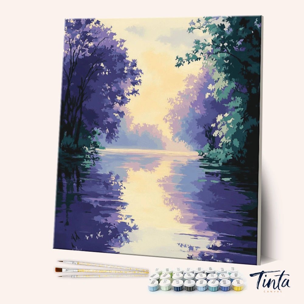 Angled display of the Lavender River paint by numbers kit showing peaceful river canvas with brushes and paint pots by Tinta Canvas