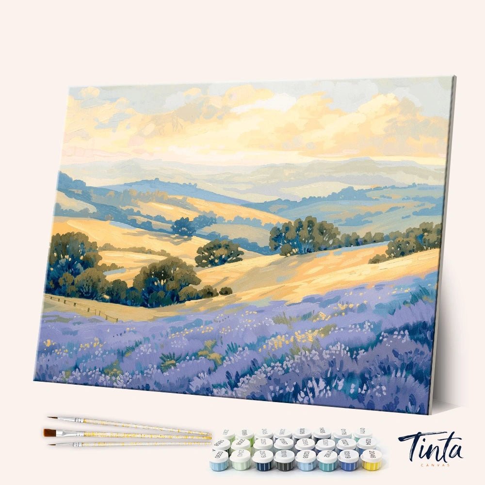 Lavender Valley Light paint by numbers kit angled display showing lavender field landscape canvas with paint pots and brushes by Tinta Canvas