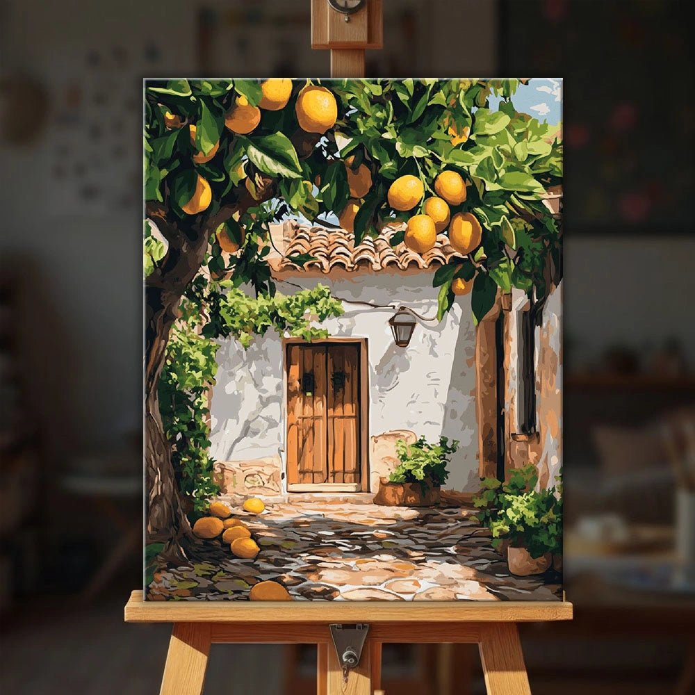 Lifestyle scene of Lemon Yard paint by numbers kit displayed on an easel creating warm Mediterranean home decor by Tinta Canvas