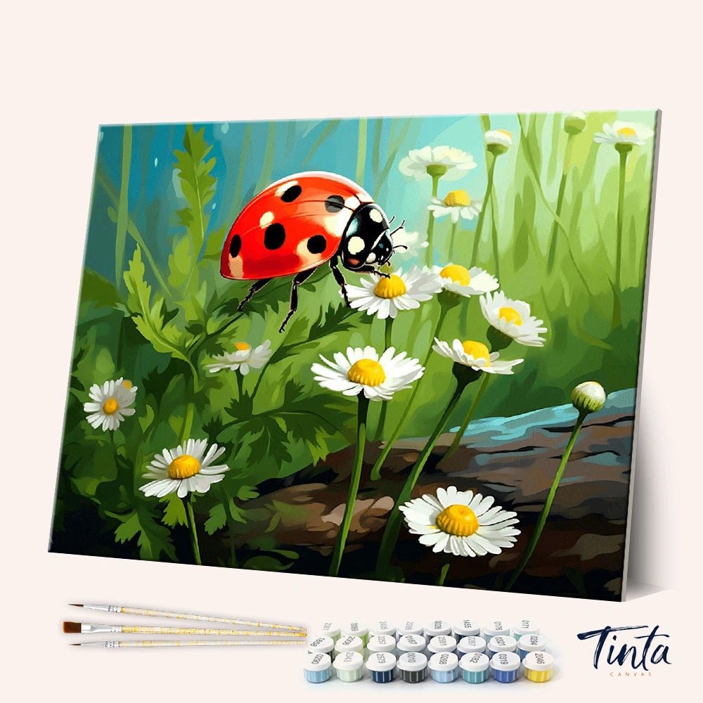 Angled display of Lucky Ladybug paint by numbers kit showing a red ladybug resting on white daisies in a green garden by Tinta Canvas