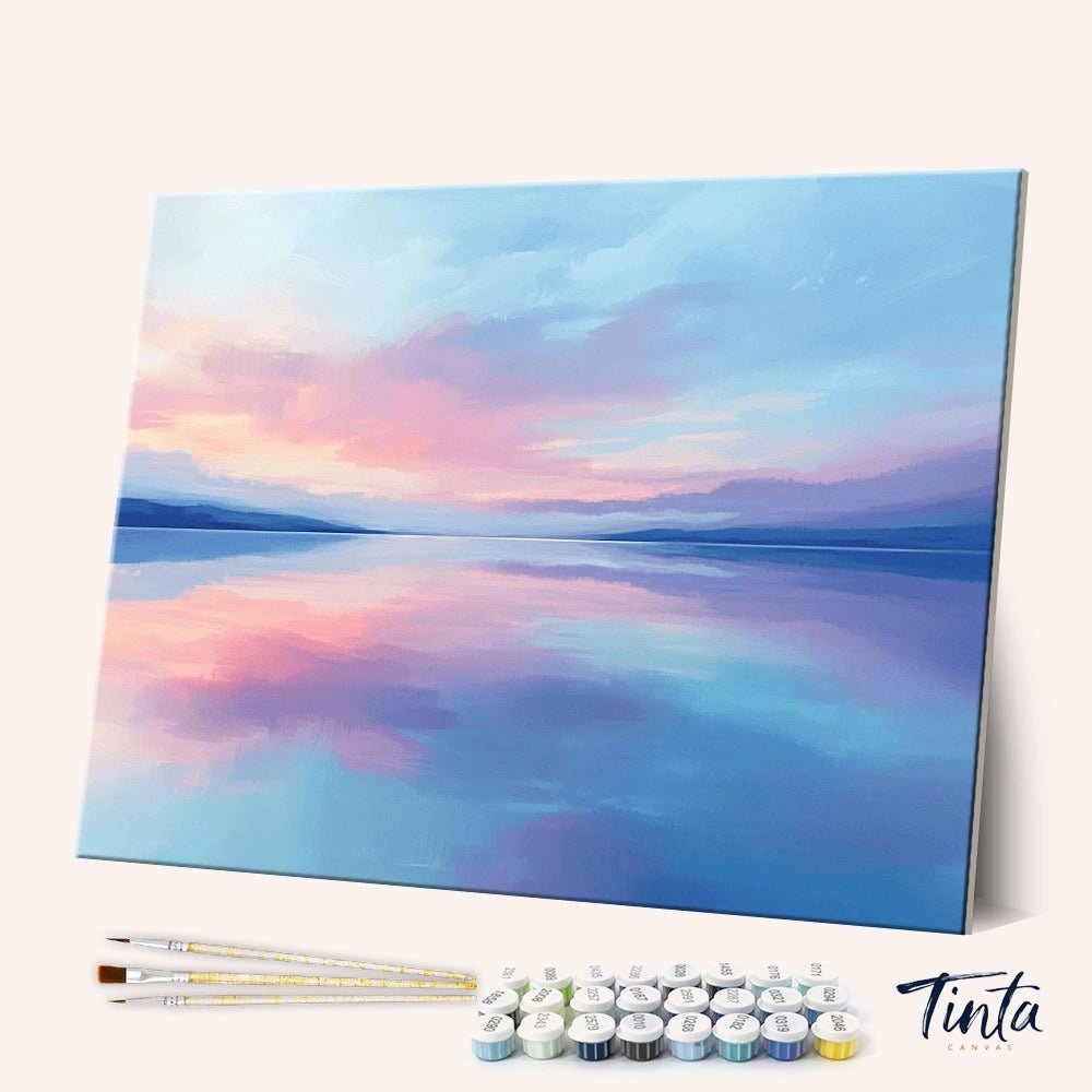 Angled display of the Morning Lake paint by numbers kit showing calm pastel lake canvas with brushes and paint pots by Tinta Canvas