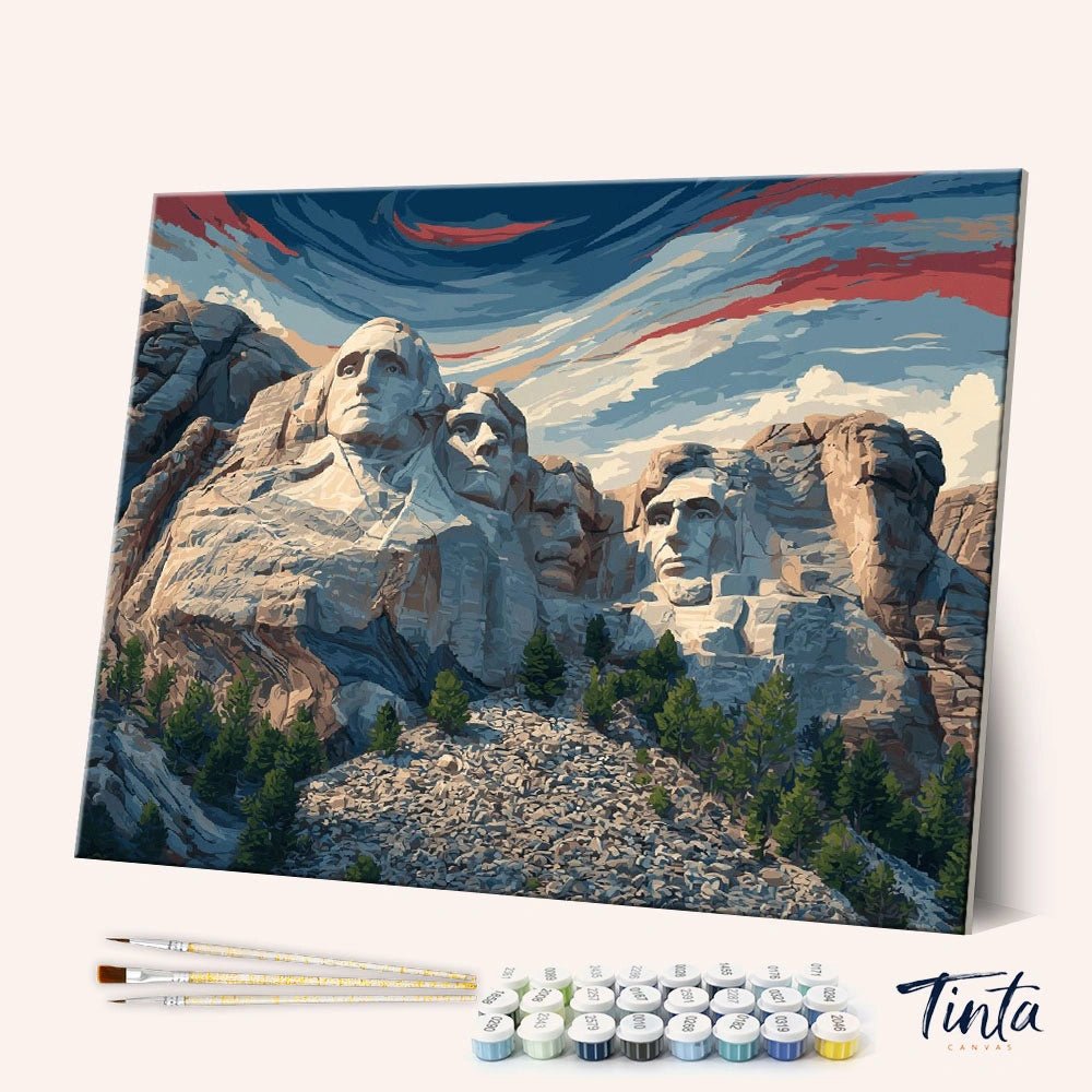 Angled display of the Mount Rushmore paint by numbers kit showing the iconic monument canvas with brushes and paints by Tinta Canvas