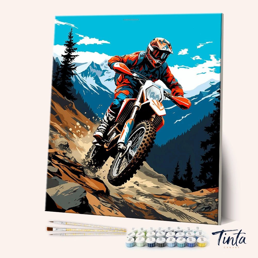 Angled display of the Mountain Trail Rider paint by numbers kit showing motocross rider racing down a mountain trail by Tinta Canvas