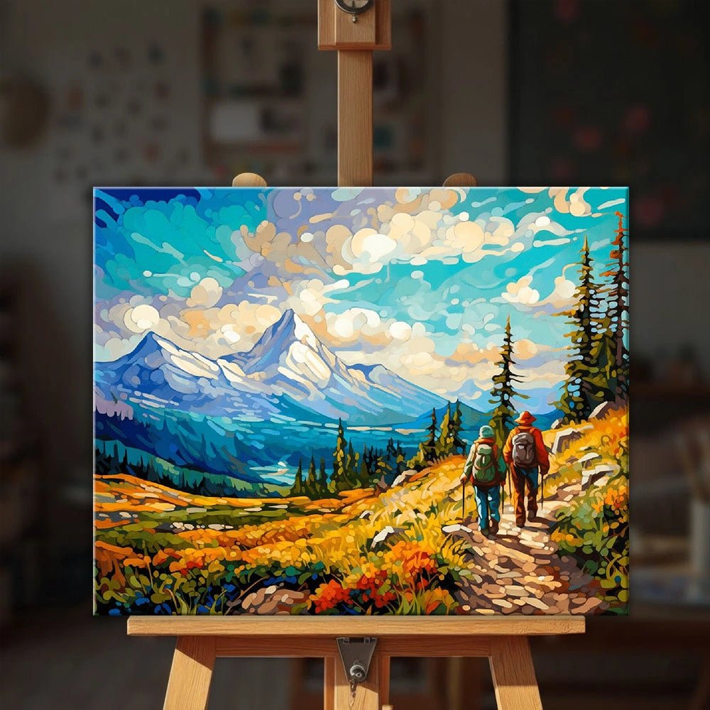 Mountain Trek paint by numbers kit displayed on an easel showing two hikers exploring a vibrant alpine meadow trail by Tinta Canvas