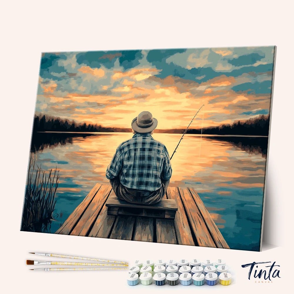 Angled display of the Old Man’s Hobby paint by numbers kit showing a fisherman sitting on a dock at sunset by Tinta Canvas