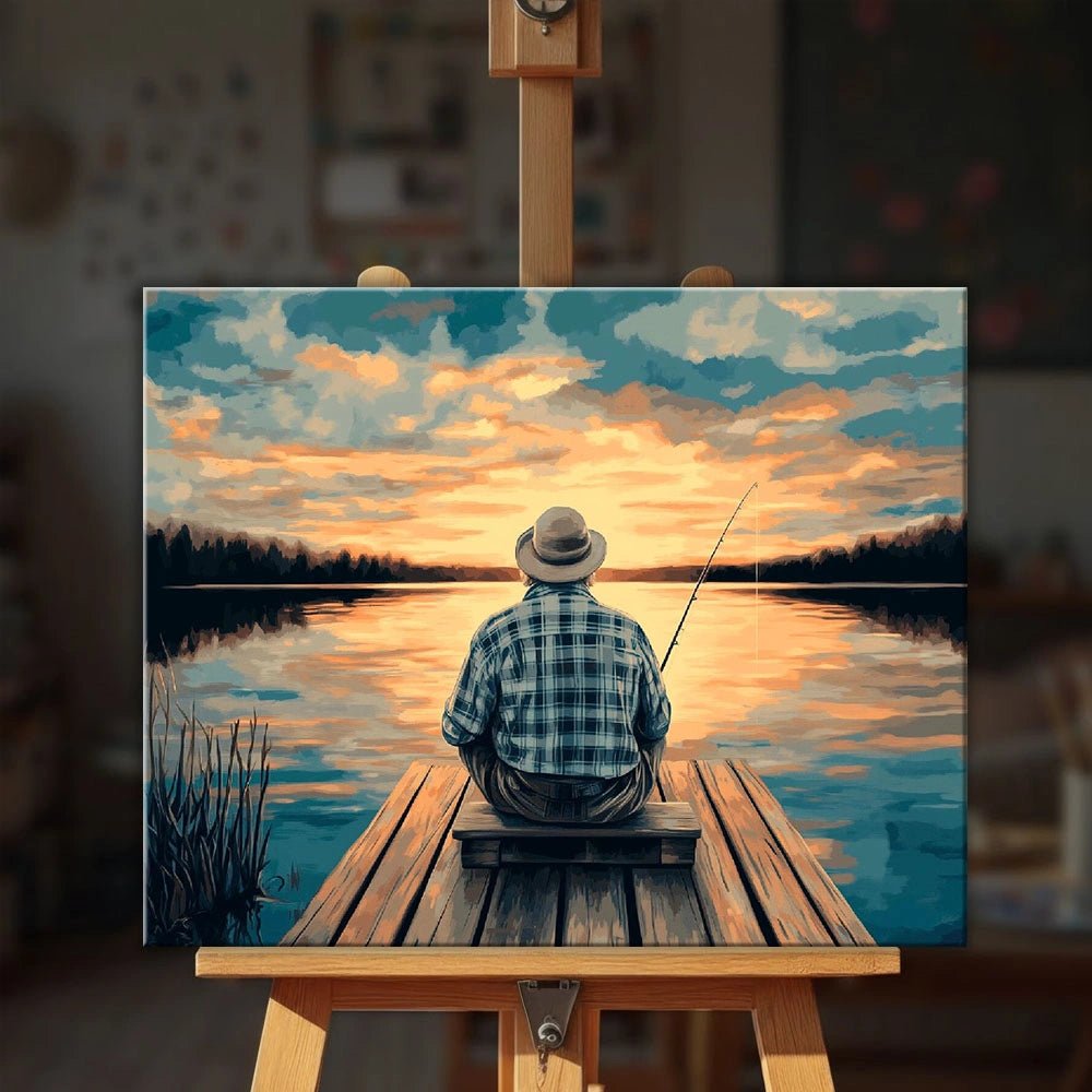 Old Man’s Hobby paint by numbers kit displayed on an easel showing a fisherman relaxing on a wooden dock by Tinta Canvas