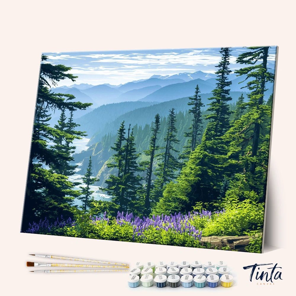 Angled display of the Olympic National Park paint by numbers kit showing evergreen forests and distant mountain ranges by Tinta Canvas