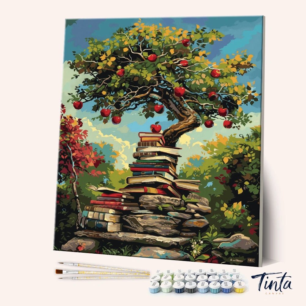 Angled view of Pages of Plenty paint by numbers kit showing apple tree growing above stacked books by Tinta Canvas