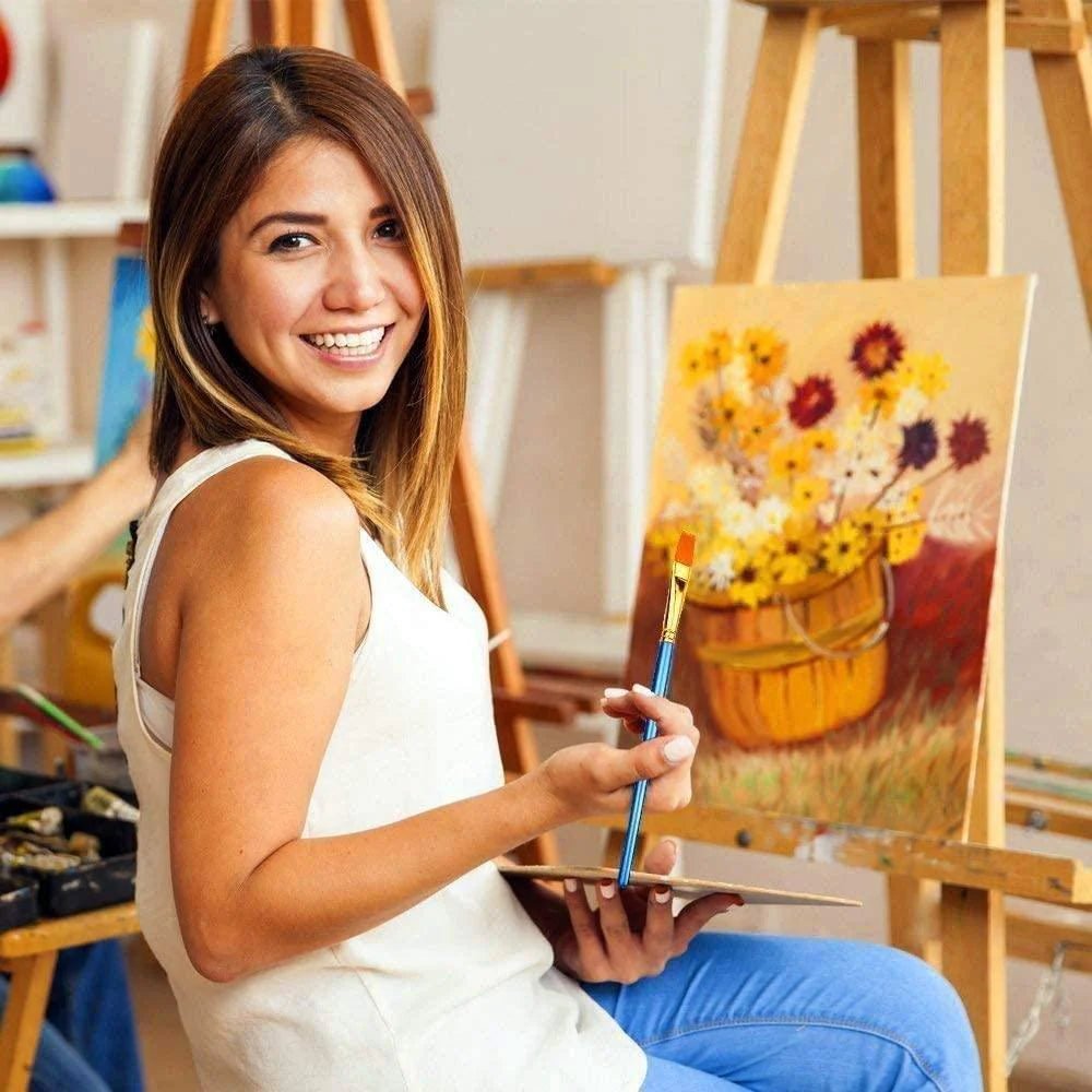 Artist using premium paint by numbers brushes on a floral canvas