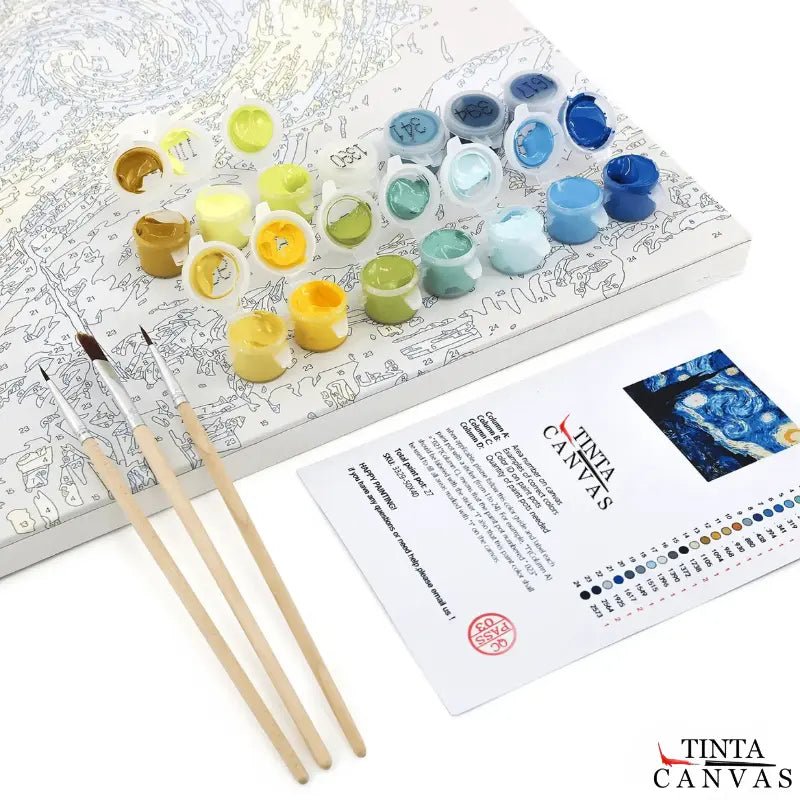 Paint by numbers kit showing numbered canvas, acrylic paint pots, fine detail brushes, and printed color key