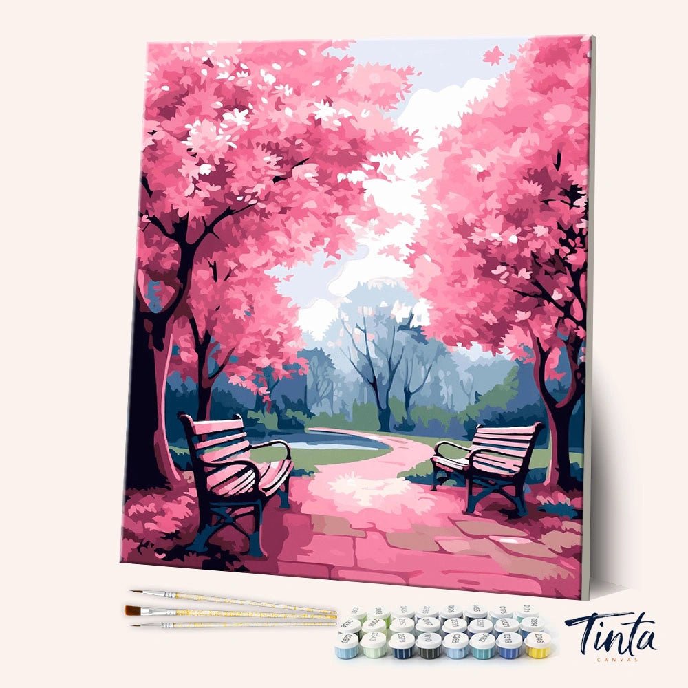 Angled view of Pink Park paint by numbers kit showing pink blossom trees, benches, and pathway with full set included by Tinta Canvas