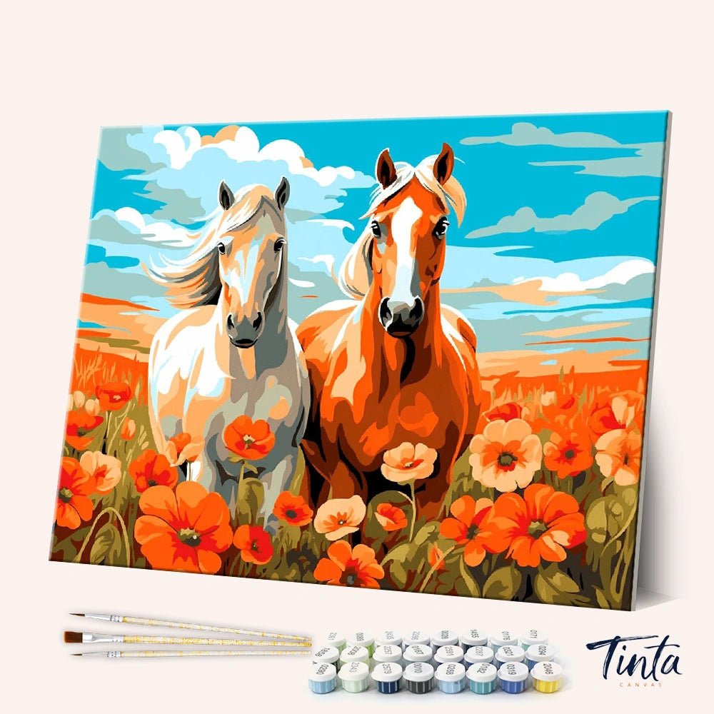 Angled display view of the Poppy Horses paint by numbers kit showing canvas, brushes, and paints with vibrant horses artwork by Tinta Canvas