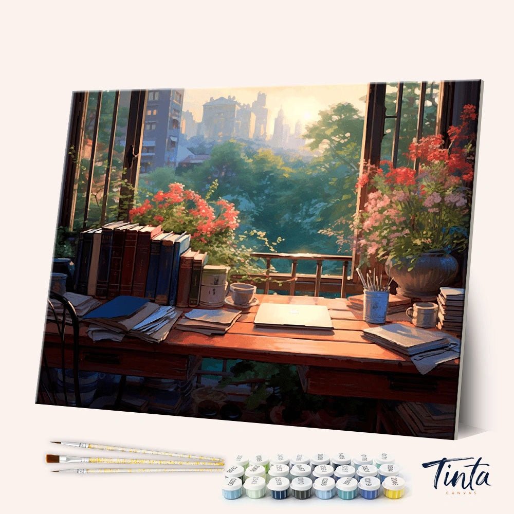Angled display of the Quiet Desk paint by numbers kit showing cozy study desk canvas with brushes and paint pots by Tinta Canvas