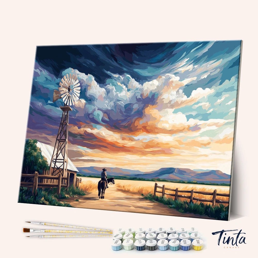 Angled view of Rancher Days paint by numbers kit showing countryside scene with windmill, horse rider, and tools included by Tinta Canvas