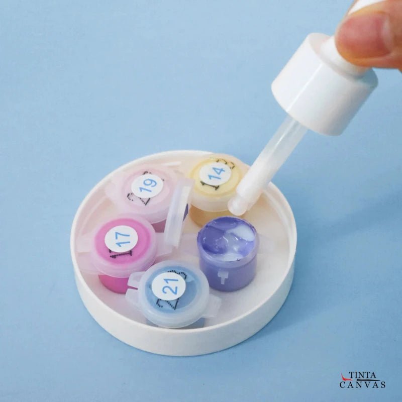 Contact lens case with colored lenses and a dropper on a light blue background