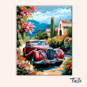 Clean artwork of Riviera Rose Drive paint by numbers kit showing classic red car beside Mediterranean villa and blooming roses by Tinta Canvas