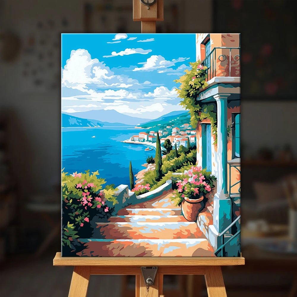Sea View Terrace paint by numbers kit displayed on an easel showing Mediterranean terrace scene with flowers and ocean view by Tinta Canvas
