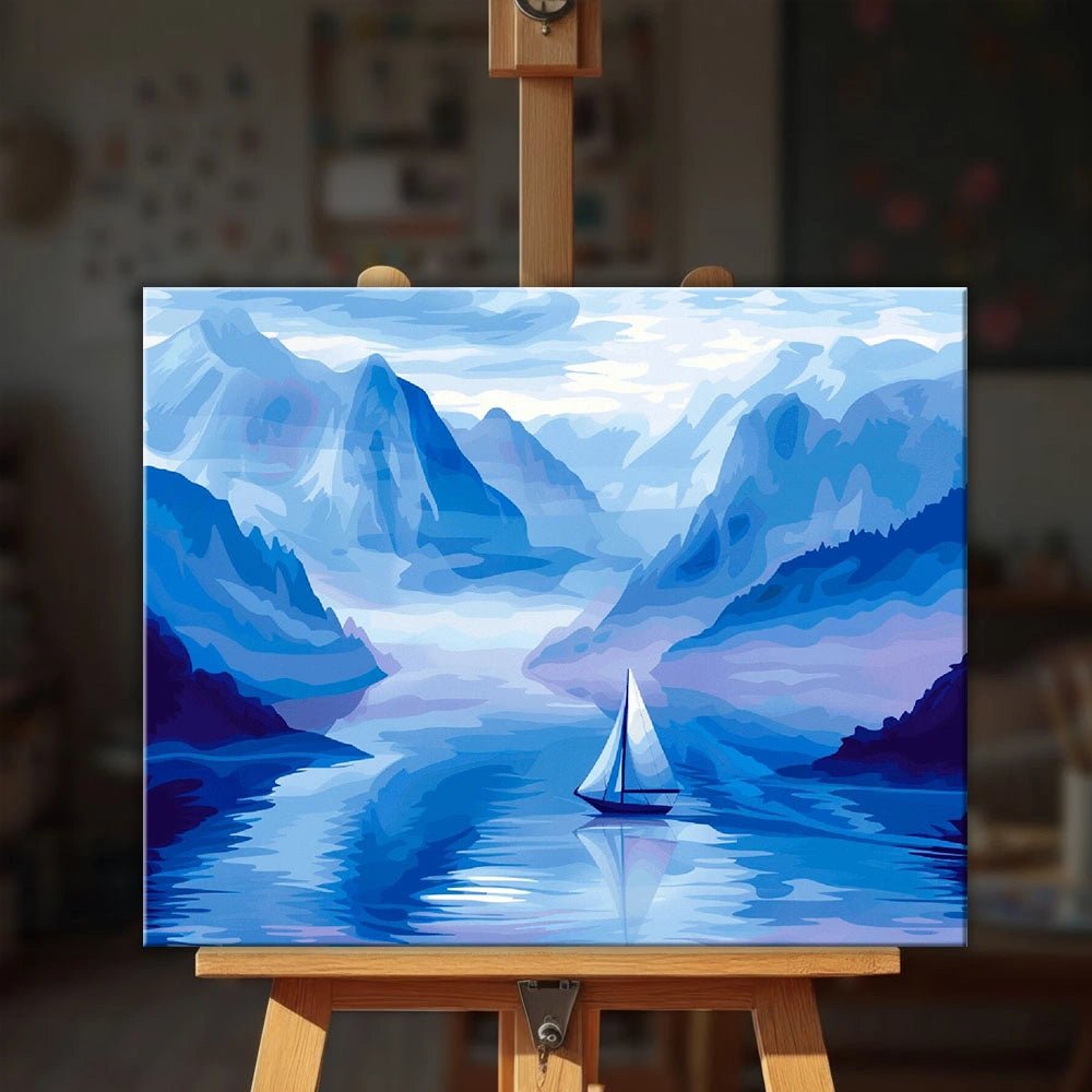 Silent Blue Passage paint by numbers kit displayed on an easel showing tranquil blue fjord landscape with sailboat by Tinta Canvas