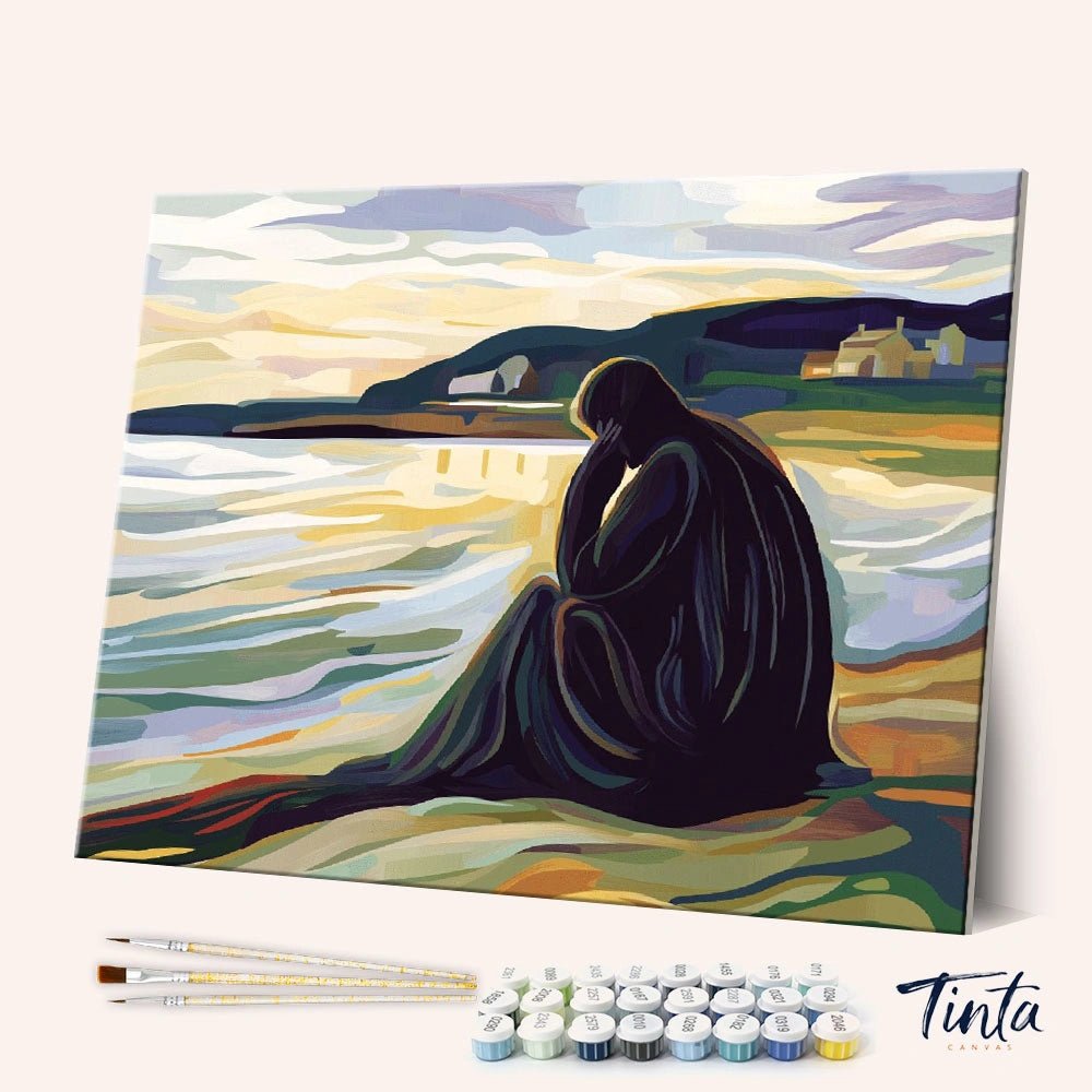 Angled display of the Silent Shore paint by numbers kit showing coastal sunset canvas with brushes and paint pots by Tinta Canvas