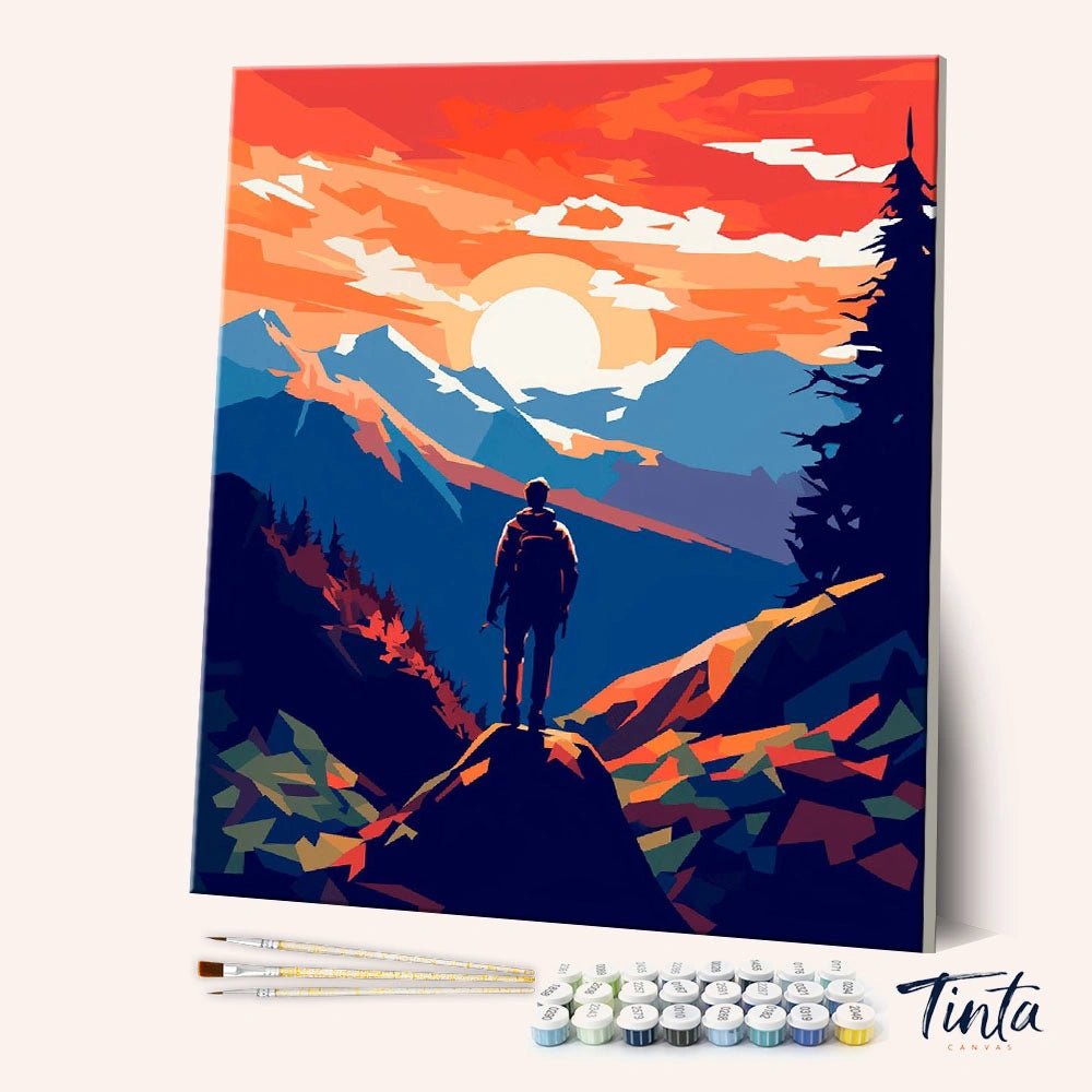 Angled display of the Summit View paint by numbers kit showing a lone hiker standing on a mountain ridge at sunset by Tinta Canvas