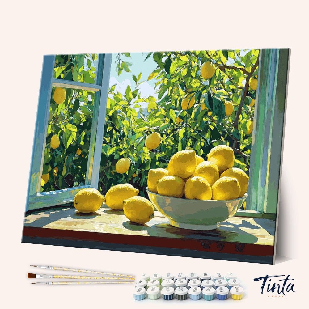 Sunlit Lemon Morning paint by numbers kit angled display showing lemon still life canvas with paint pots and brushes by Tinta Canvas