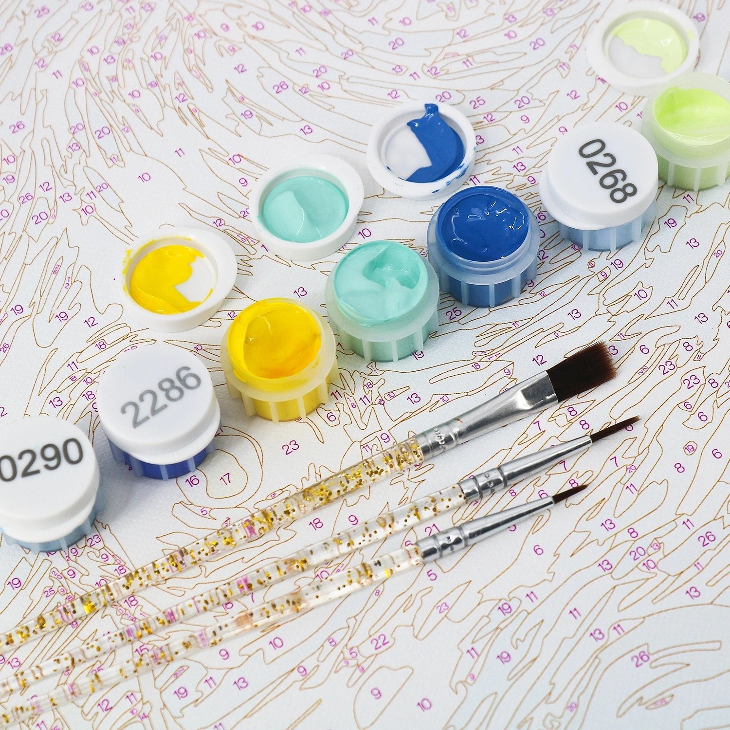 Tinta Canvas paint by numbers kit close-up showing numbered canvas acrylic paint pots and detail brushes for adults DIY painting project