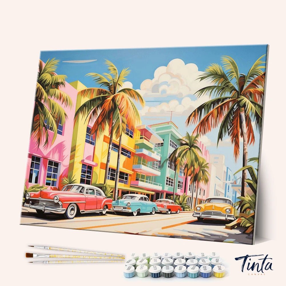 Welcome to Miami paint by numbers kit shown in angled view with colorful buildings, palm trees, and vintage cars