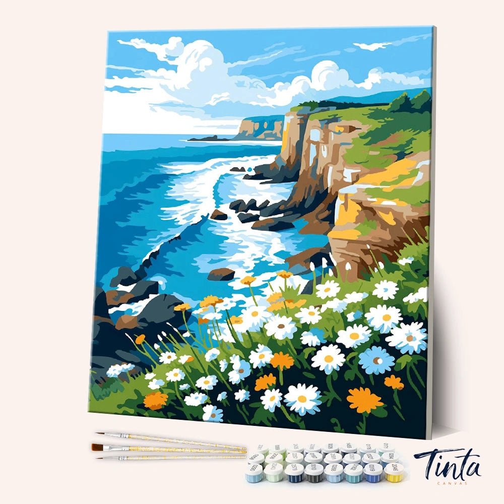 Angled view of Wildflower Cliffside paint by numbers kit featuring coastal cliffs and blooming daisies by Tinta Canvas