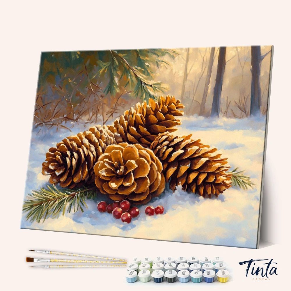 Winter Pinecones paint by numbers kit angled view showing pinecones on snow with red berries and evergreen branches